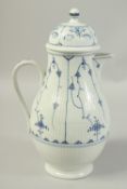 A LARGE VOLKSTEDT COFFEE POT decorated with a stylised flower decoration in under glaze blue. Circa.