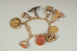 A SUPERB 18CT GOLD CHARM BRACELET set with seven fob seals and a Queen Anne gold guinea.