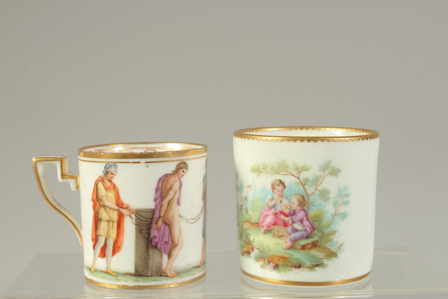 A SEVRES STYLE COFFEE CAN, painted with two children playing, incised marks near foot rim, and a