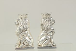 A PAIR OF SILVER PLATED ROYAL LIONS SALT AND PEPPERS. 3.25