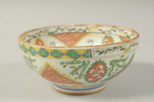 A TURKISH OTTOMAN KUTAHYA BOWL, painted with a figure to the centre, 18.5cm diameter.