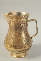 A TURKISH OTTOMAN GILDED COPPER JUG, 24.5cm high.