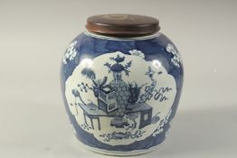 AN EARLY 20TH CENTURY CHINESE BLUE AND WHITE PORCELAIN JAR AND HARDWOOD COVER, decorated with panels