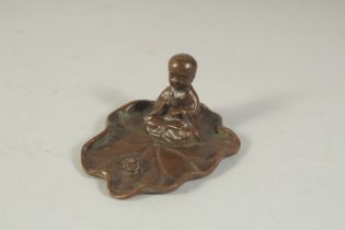 A BRONZE OKIMONO OF A LOTUS CHILD, base 8cm x 6.5cm.