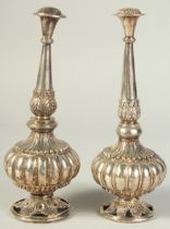 A FINE PAIR OF SILVER ROSEWATER SPRINKLERS, with lobed floral body, the spout-heads engraved as