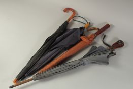 A COLLECTION OF FOUR UMBRELLAS WITH BAKELITE HANDLES, (4).