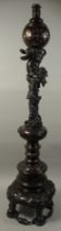 A VERY FINE JAPANESE MEIJI PERIOD BRONZE FLOOR STANDING LAMP, the mast relief-decorated with foo
