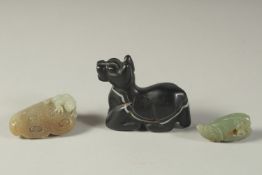 TWO FINELY CARVED JADE PIECES, together with a black agate reclining animal, (3).