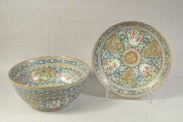 A VERY LARGE CHINESE BLUE GROUND FAMILLE ROSE PORCELAIN PUNCH BOWL AND UNDER-PLATE, enamel painted