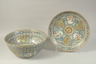 A VERY LARGE CHINESE BLUE GROUND FAMILLE ROSE PORCELAIN PUNCH BOWL AND UNDER-PLATE, enamel painted