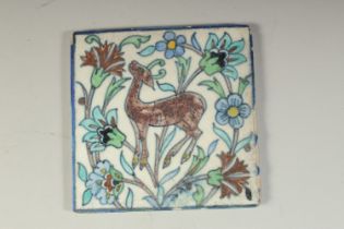 AN EARLY 20TH ARMENIAN JERUSELUM GLAZED POTTERY TILE, depicting a deer, 12.5cm x 12.5cm.