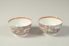 A PAIR OF CHINESE EXPORT PORCELAIN CUPS, each painted with scenes of figures, 8.5cm diameter.