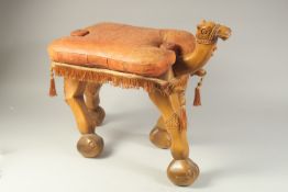 A EARLY-MID 20TH CENTURY EGYPTIAN CARVED WOOD CAMEL STOOL, with original embossed leather cushion,