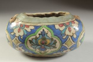 AN UNUSUAL PERSIAN QAJAR GLAZED POTTERY KASHKUL BEGGER'S BOWL, 23cm wide.