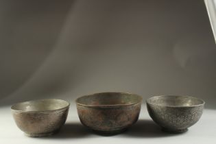 A COLLECTION OF THREE 18TH-19TH CENTURY PERSIAN ENGRAVED TINNED COPPER BOWLS, largest 21cm