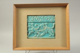 A 12TH CENTURY KASHAN TURQUOISE GLAZED POTTERY TILE, with relief decoration depicting lions/