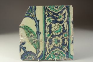 A FINE EALY 17TH CENTURY OTTOMAN DAMASCUS GLAZED POTTERY TILE, with floral decoration, (af), 25cm