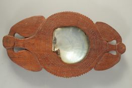 AN UNUSUAL TRIBAL OR POSSIBLY OCEANIC CARVED WOODEN OFFERING TRAY, with inset mother of pearl shell,