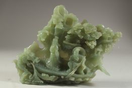 A LARGE CHINESE CARVED JADE GROUP DEPICTING FIGURES ON A BOAT, with a dragon and back-panel of trees