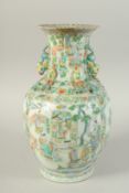 A CHINESE FAMILLE VERTE PORCELAIN VASE, painted with panels of figures, the neck with moulded