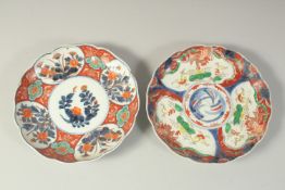 TWO JAPANESE IMARI PORCELAIN PLATES, painted with panels of flora and gilt highlights, one with