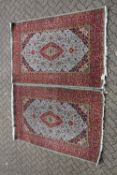 A GOOD PAIR OF PERSIAN PART-SILK RUGS, red ground with stylised decoration, 222cm x 140cm, (2).