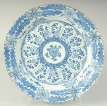 A CHINESE KANGXI PERIOD BLUE AND WHITE PORCELAIN CHARGER, with central flowering lotus medallion