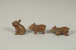 THREE SMALL BRONZE PIGS, each approx. 2.5cm, (3).