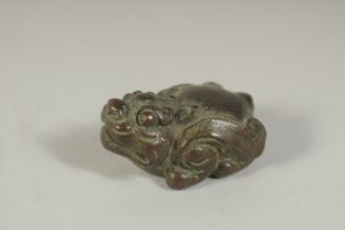 A BRONZE OKIMONO OF A TEMPLE DOG, 4.5cm long.