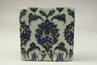 A 17TH CENTURY SYRIA DAMASCUS GLAZED POTTERY TILE, 23cm x 23cm.