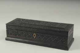 A FINE MID 19TH CENTURY ANGLO INDIAN CARVED EBONY BOX, 39.5cm x 11.5cm.