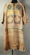 AN ISLAMIC PAINTED TALISMANIC SHIRT, with panels of inscriptions all over and heightened with gilt