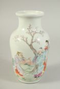 A CHINESE FAMILLE ROSE PORCELAIN VASE, enamel painted with figures in a garden, 21.5cm high.