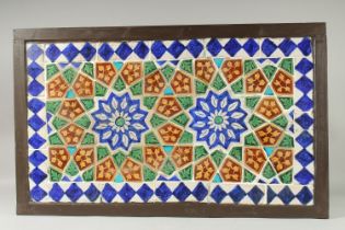 A FINE LARGE 19TH CENTURY INDIAN GLAZED POTTERY TILED PANEL, inset within a wooden frame; possibly a