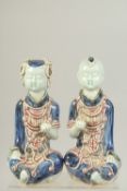 A PAIR OF CHINESE UNDERGLAZE RED AND BLUE PORCELAIN CHILD FIGURES, 23cm high.