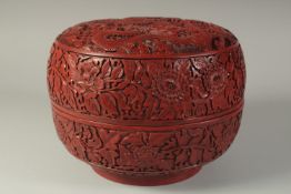 A FINE AND LARGE CHINESE CINNABAR LACQUER CIRCULAR DRAGON BOX, the lid carved with two dragons and