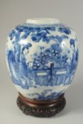 A LARGE CHINESE KANGXI BLUE AND WHITE PORCELAIN JAR ON HARDWOOD STAND, the jar painted with female