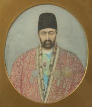 A VERY FINE PERSIAN QAJAR GOUACHE OVAL PORTRAIT PAINTING ON PAPER, circa 1880, depicting a Qajar