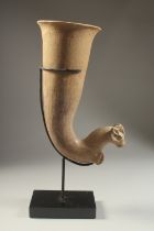 A LARGE POTTERY GOAT FORMED RHYTON, elevated on a purpose-made stand, rhyton 32cm high.