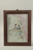 AN EARLY 20TH CENTURY CHINESE FAMILLE ROSE PORCELAIN PLAQUE depicting musicians, inset within a
