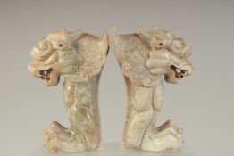 A PAIR OF CHINESE OR TIBETAN CARVED STONE STYLISED TEMPLE LIONS, 16cm high.