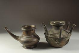 AN 18TH CENTURY SOUTH INDIAN BRONZE EWER, 24cm wide, together with a multi-spouted lota with figural