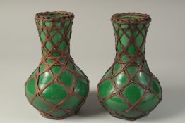 A PAIR OF JAPANESE AWAJI WARE GREEN GLAZED PORCELAIN VASES, with woven bamboo overlay, each with
