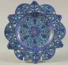 A FINE LATE 19TH CENTURY NORTH INDIAN MULTAN OPENWORKED GLAZED POTTERY DISH, painted with foliate
