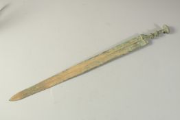 A CAST BRONZE SWORD, in excavated condition, 66cm long.