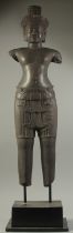 A FINE AND LARGE CAMBODIAN KHMER OR KHMER STYLE CARVED BLACK STONE FIGURE OF A MALE DEITY, raised on