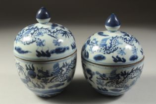 A PAIR OF CHINESE BLUE AND WHITE LIDDED DRAGON BOWLS, 17cm high.