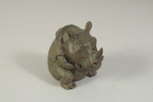 A BRONZE OKIMONO OF A RHINOCEROS, 6.5cm high.