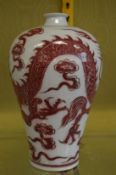 A Chinese Meiping style vase decorated in red with dragons.