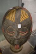 A large carved wood and painted tribal mask.
